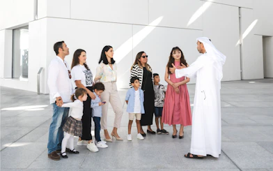 Family with guide at Louvre Abu Dhabi courtyard.