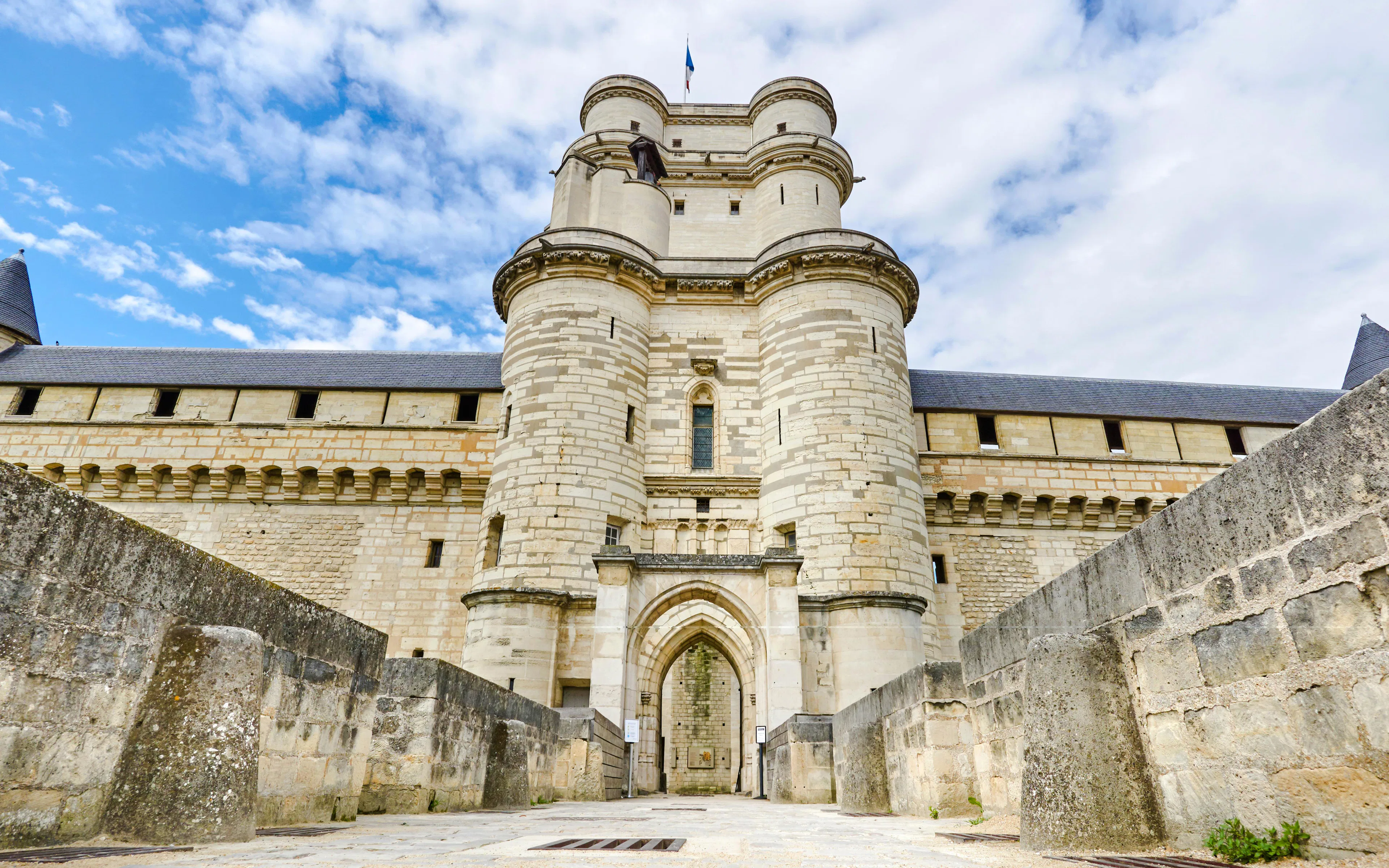 Castle of Vincennes entrance with stone walls and towers, Paris, France.