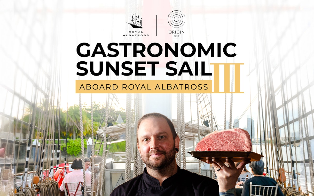 Chef holding steak aboard Royal Albatross during sunset dinner cruise.
