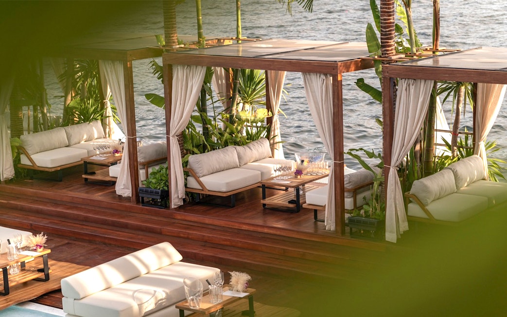 Private cabana with seating and ocean view at Yona Beach Club, Phuket.