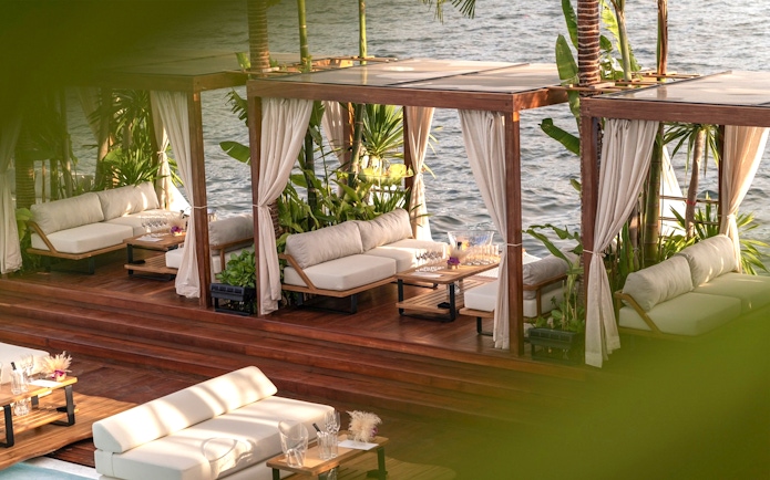 Private cabana with seating and ocean view at Yona Beach Club, Phuket.