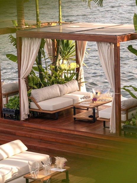 Private cabana with seating and ocean view at Yona Beach Club, Phuket.