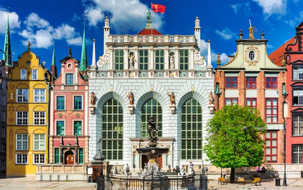 Gdańsk Artus Court with Neptune Fountain on a sunny day.