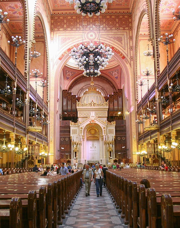 Interior of Dohany Street Synagogue in Budapest, featuring ornate architecture and chandeliers.