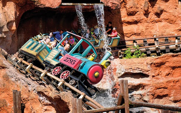 Roller coaster descending a steep track with passengers at Walibi Belgium, Wavre.