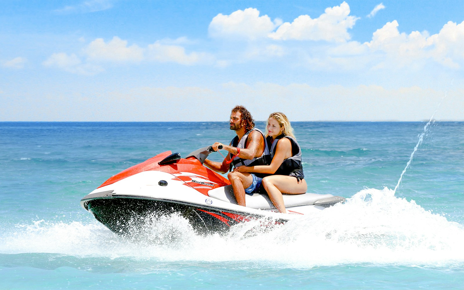 Guests jet skiing on clear waters near Bimini, Bahamas.