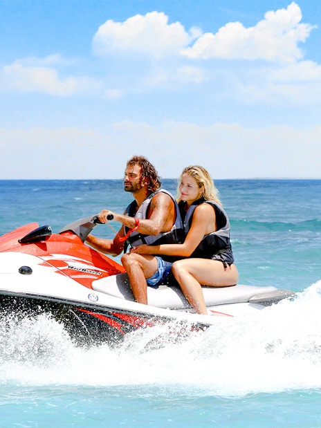Guests jet skiing on clear waters in Bimini.