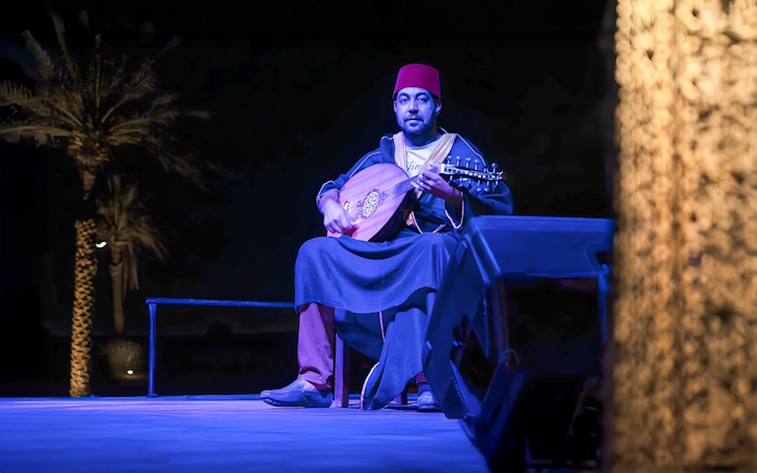 Man playing traditional Arabic music at a royal dinner in Dubai.