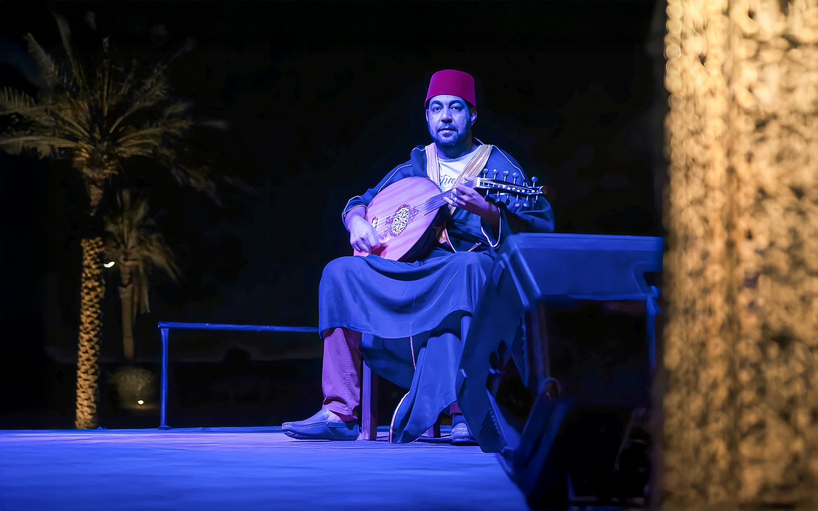 Man playing traditional Arabic music at a royal dinner in Dubai.