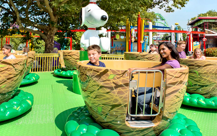 Visitors enjoying the Woodstock Whirlybirds ride at Dorney Park, featuring Snoopy.