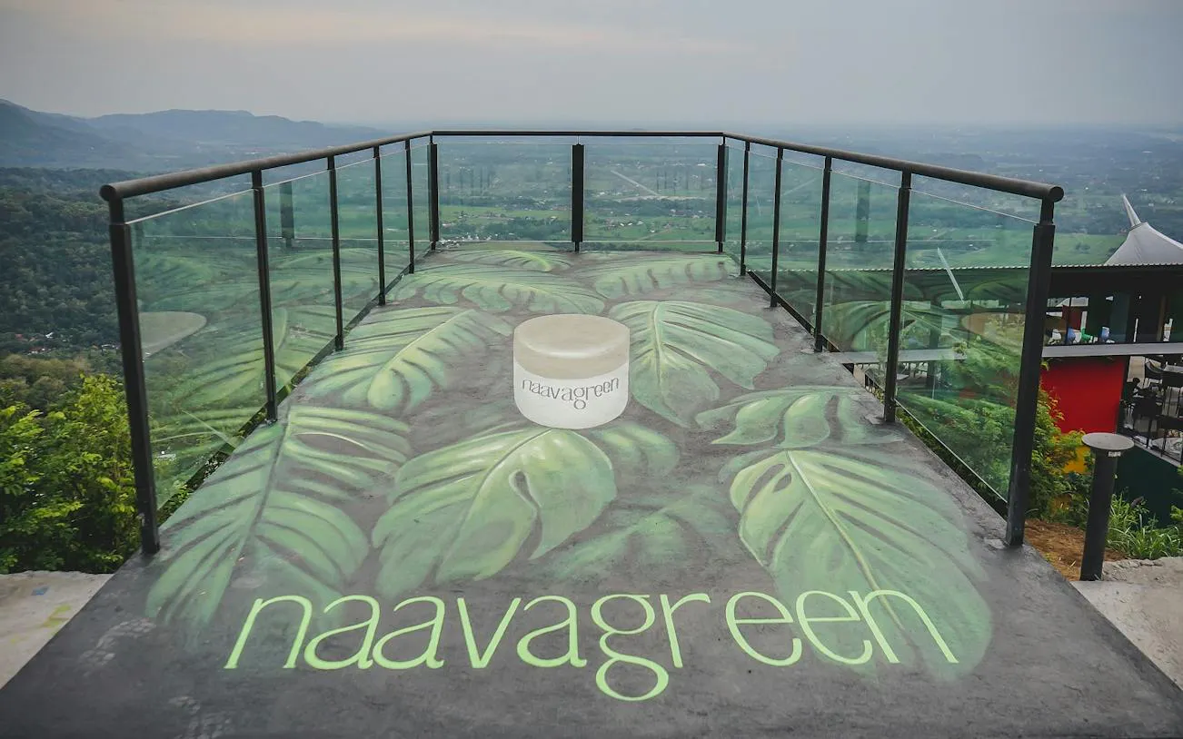 Observation deck with leaf mural overlooking lush landscape, Dubai.