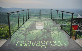 Observation deck with leaf mural overlooking lush landscape, Dubai.