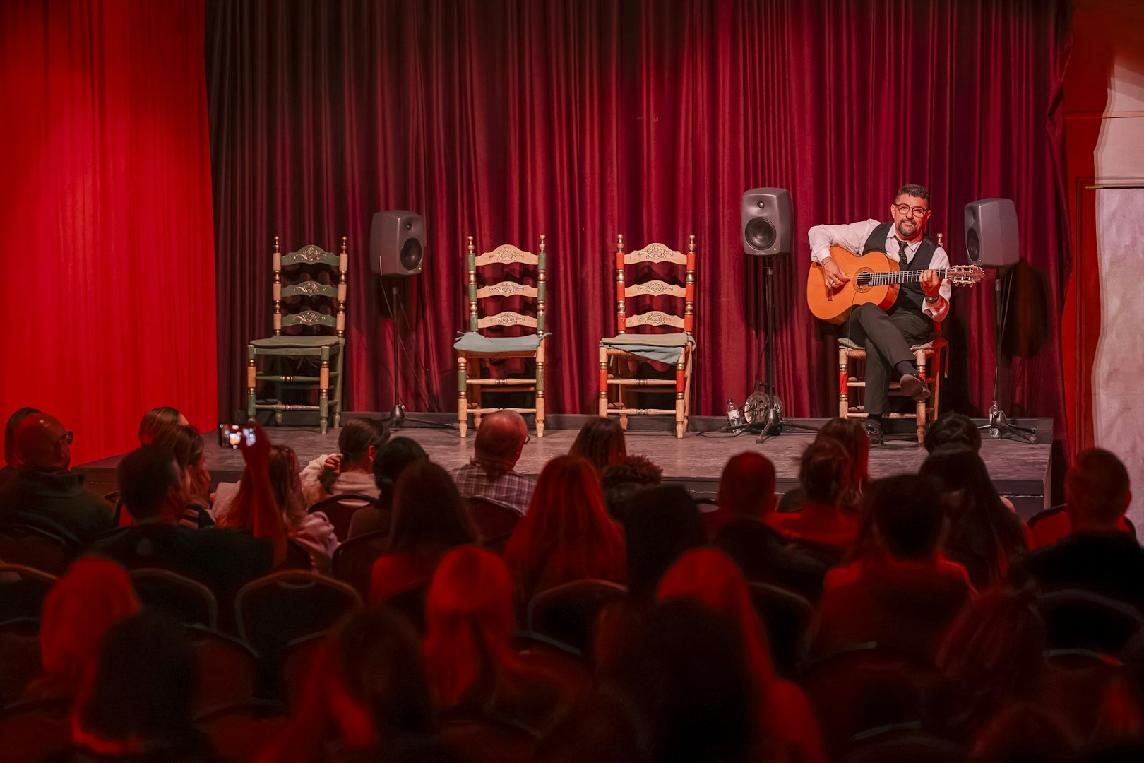 Guitarist performing at Palau Dalmases Flamenco Show in Barcelona.