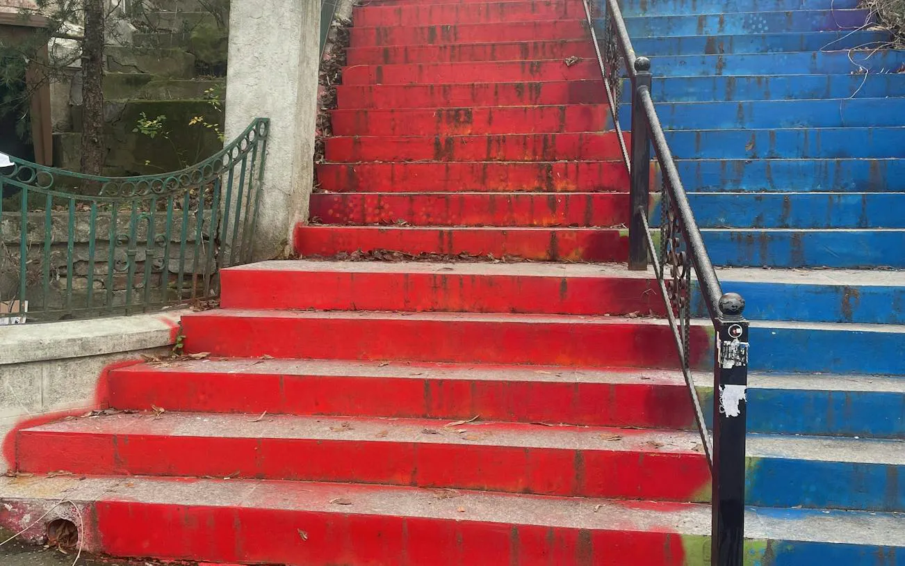 Colorful red and blue stairs in Cotroceni, Bucharest, part of a self-guided city exploration game.