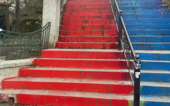 Colorful red and blue stairs in Cotroceni, Bucharest, part of a self-guided city exploration game.