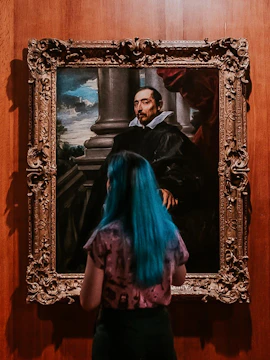 Visitor viewing a portrait at Calouste Gulbenkian Museum, Lisbon.