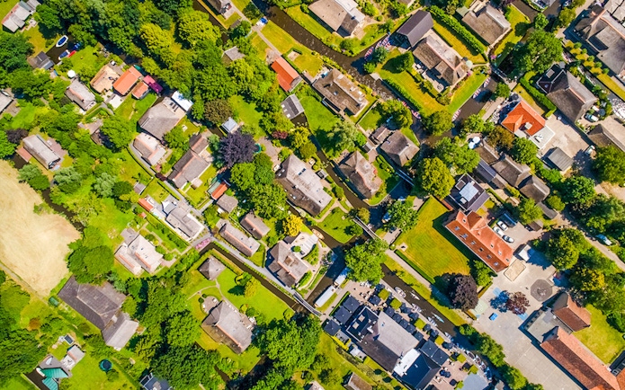 Aerial view of Giethoorn village with canals, green spaces, and traditional houses.