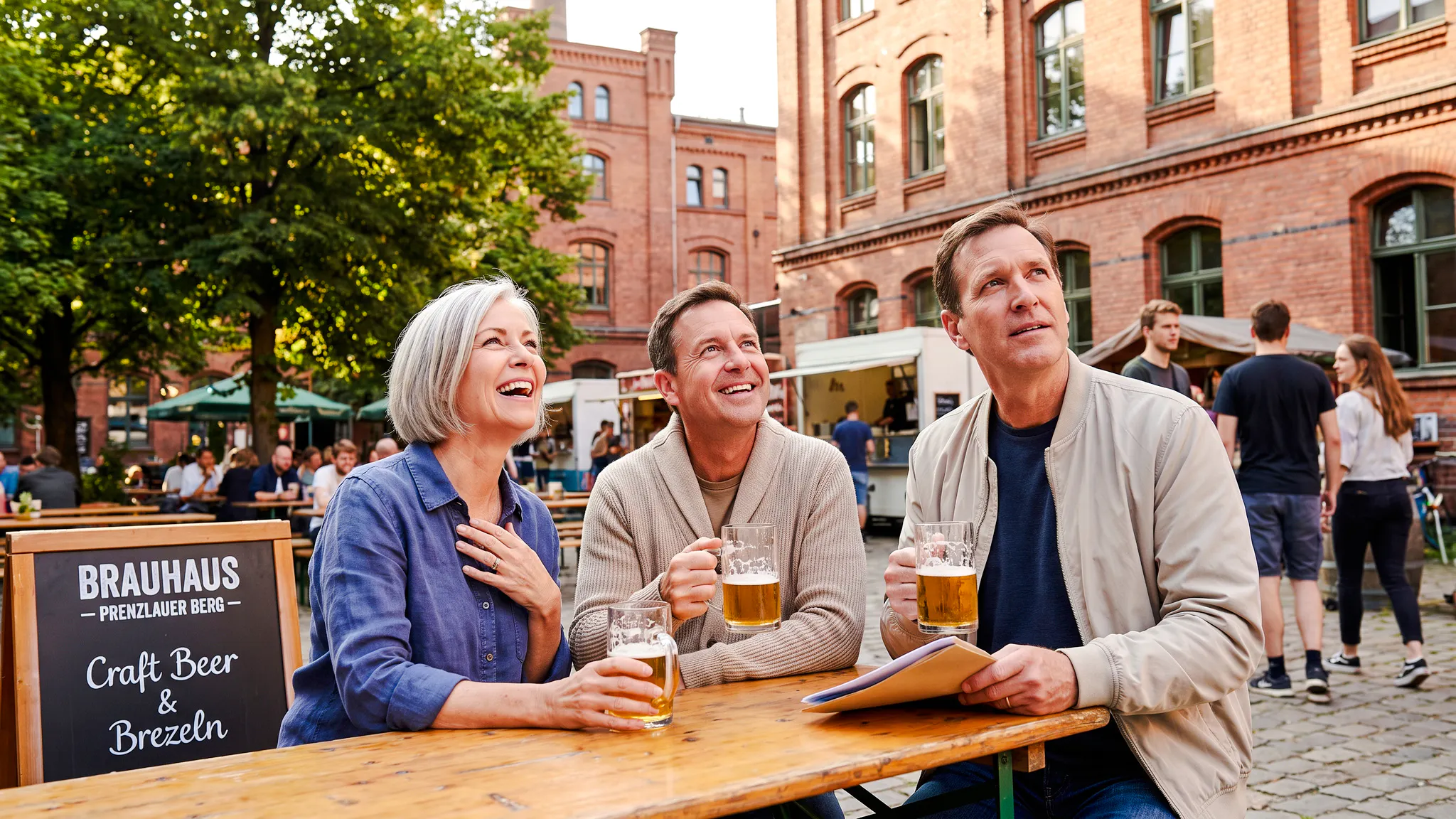 People enjoying beer at an outdoor table during Berlin Oktoberfest walking tour.