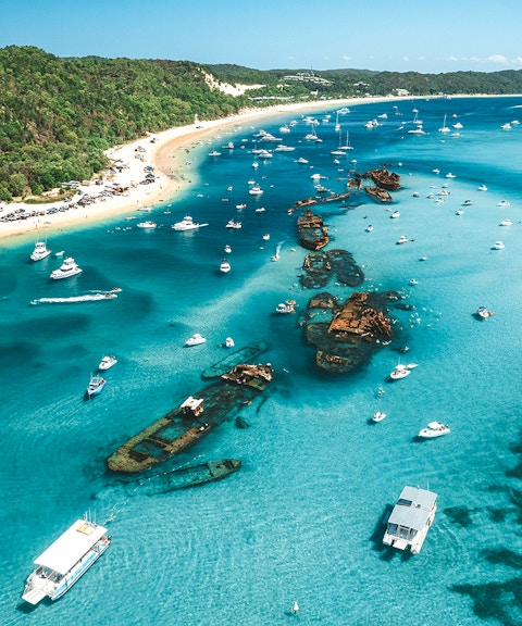 Aerial view of Tangalooma wrecks with boats in Moreton Bay, Queensland, Australia.