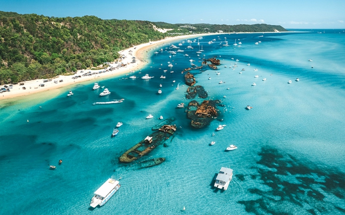 Aerial view of Tangalooma wrecks with boats in Moreton Bay, Queensland, Australia.