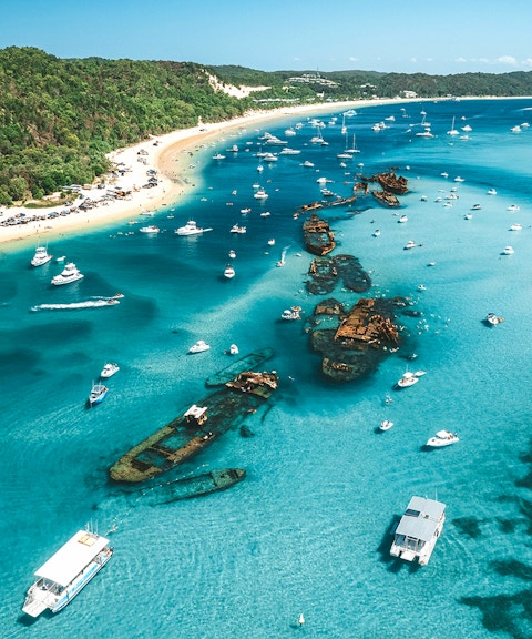 Aerial view of Tangalooma wrecks with boats in Moreton Bay, Queensland, Australia.