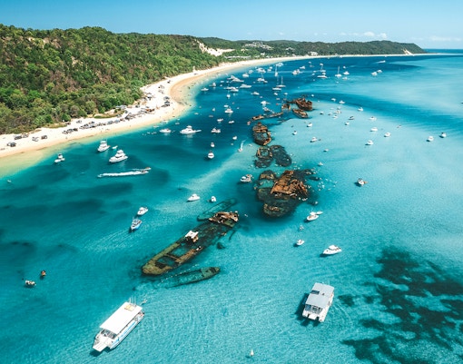 Aerial view of Tangalooma wrecks with boats in Moreton Bay, Queensland, Australia.