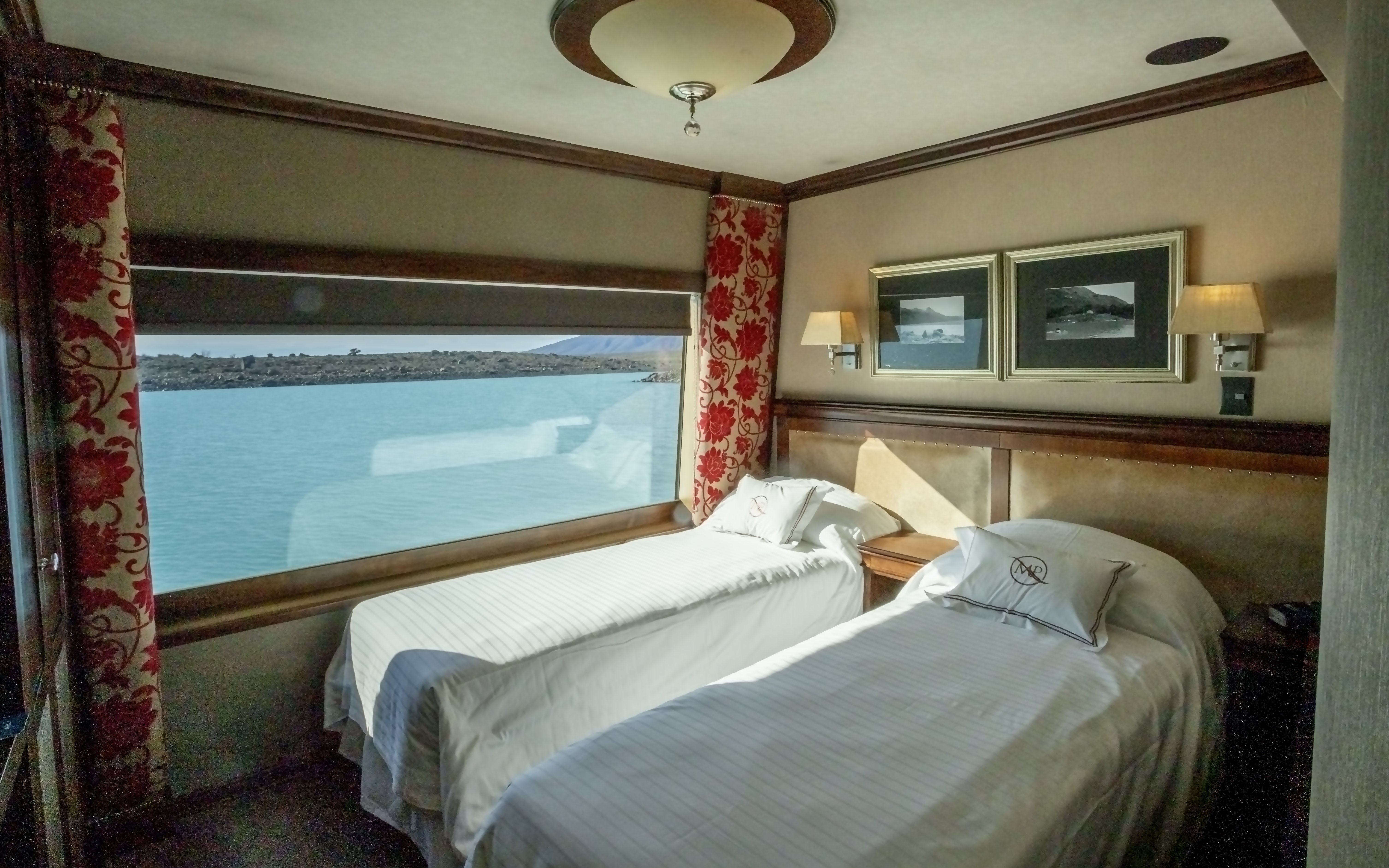 Deluxe room with twin beds and lake view on Spirit of the Glaciers tour boat.