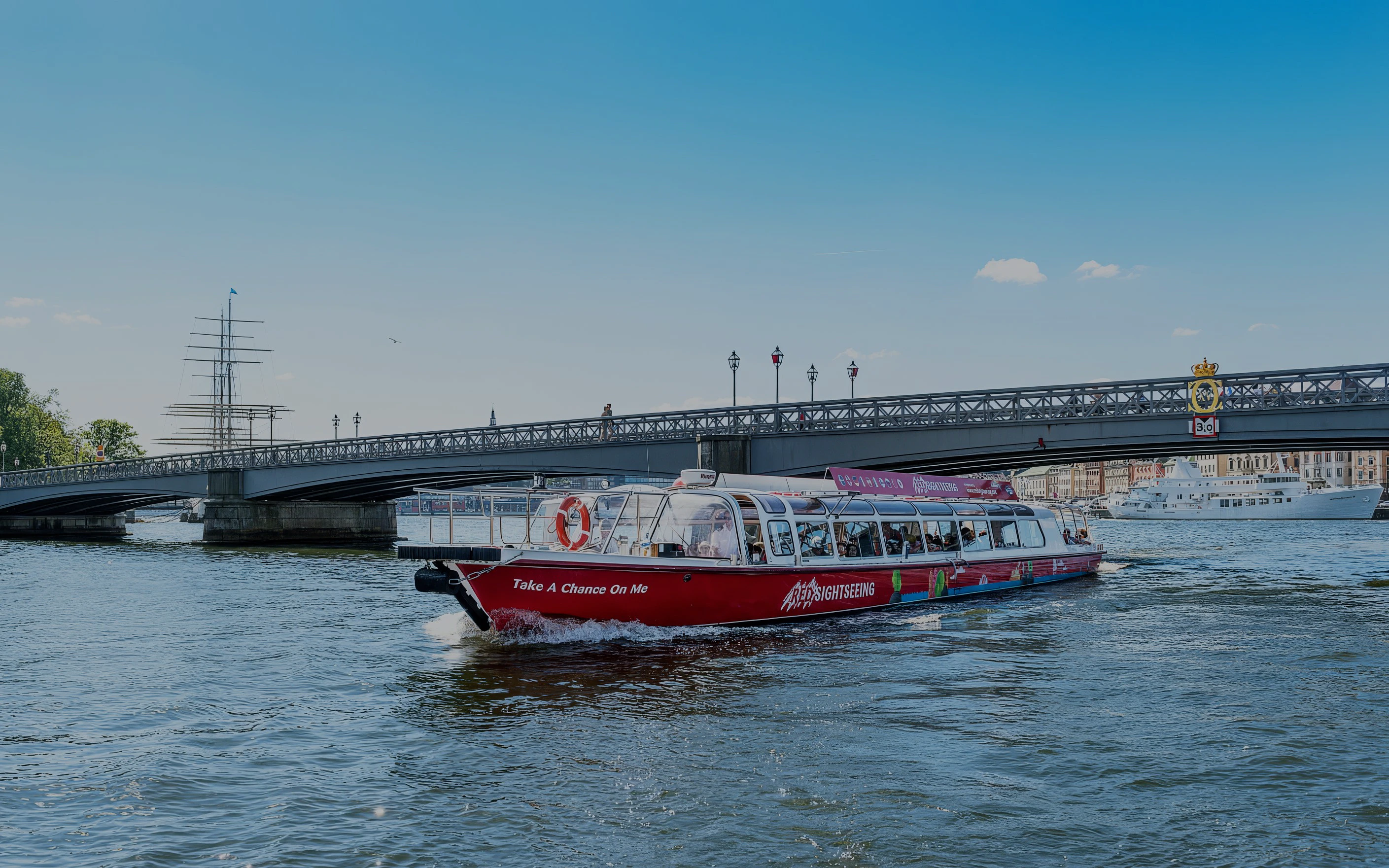 Sightseeing boat on a canal near a bridge in Stockholm, Sweden.
