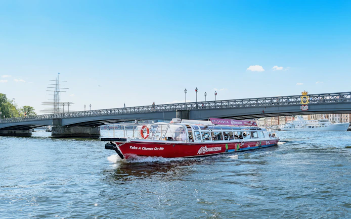 Sightseeing boat on a canal near a bridge in Stockholm, Sweden.
