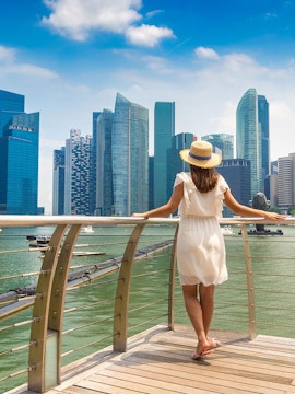 Woman overlooking Marina Bay skyline in Singapore.
