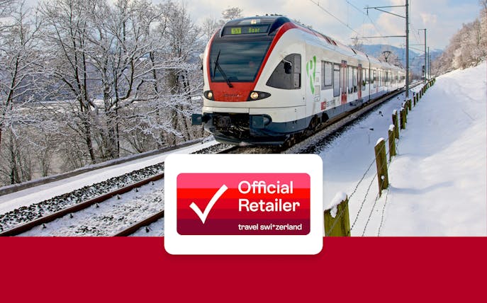 Train traveling through snowy Swiss landscape with Swiss Travel Pass logo.