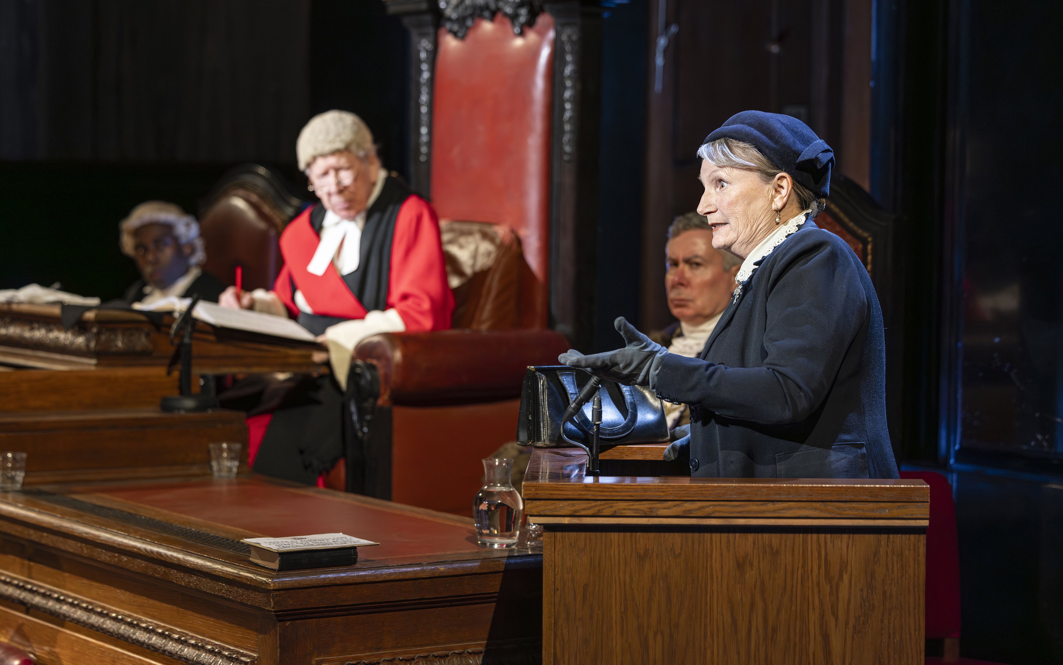 Courtroom scene from "Witness for the Prosecution" performance with actors in period costumes.