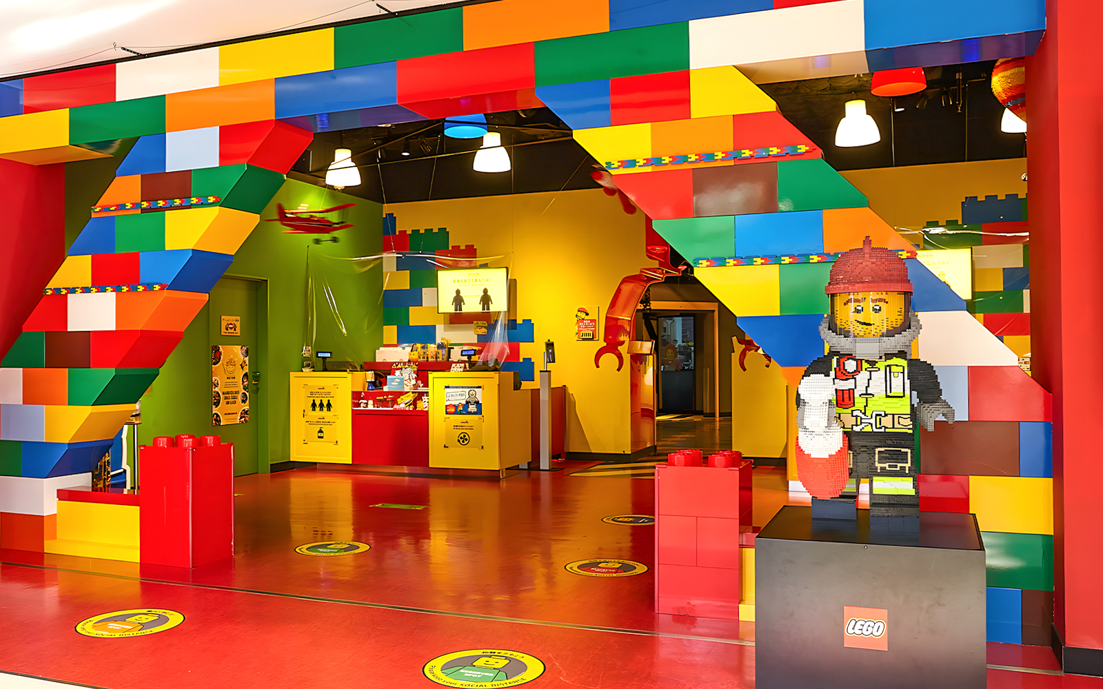 Entrance of Legoland Kansai with colorful Lego arch and firefighter Lego figure.