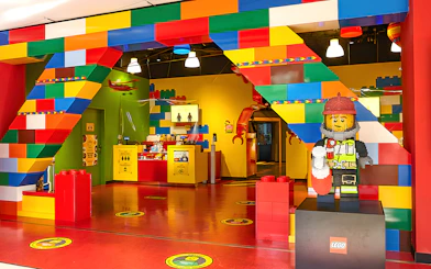 Entrance of Legoland Kansai with colorful Lego arch and firefighter Lego figure.