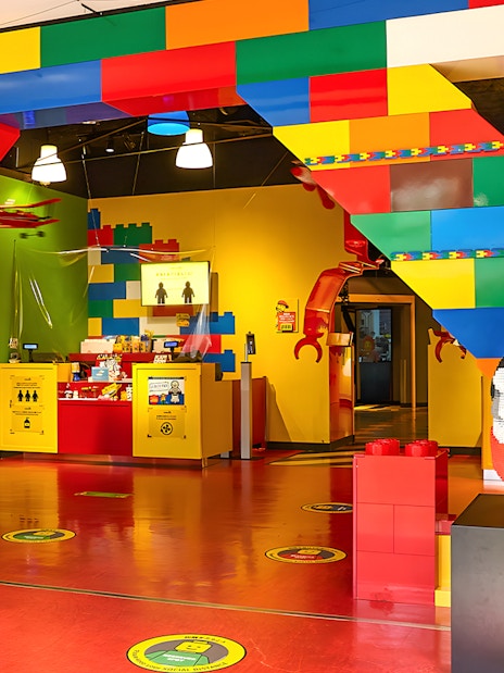 Entrance of Legoland Kansai with colorful Lego arch and firefighter Lego figure.