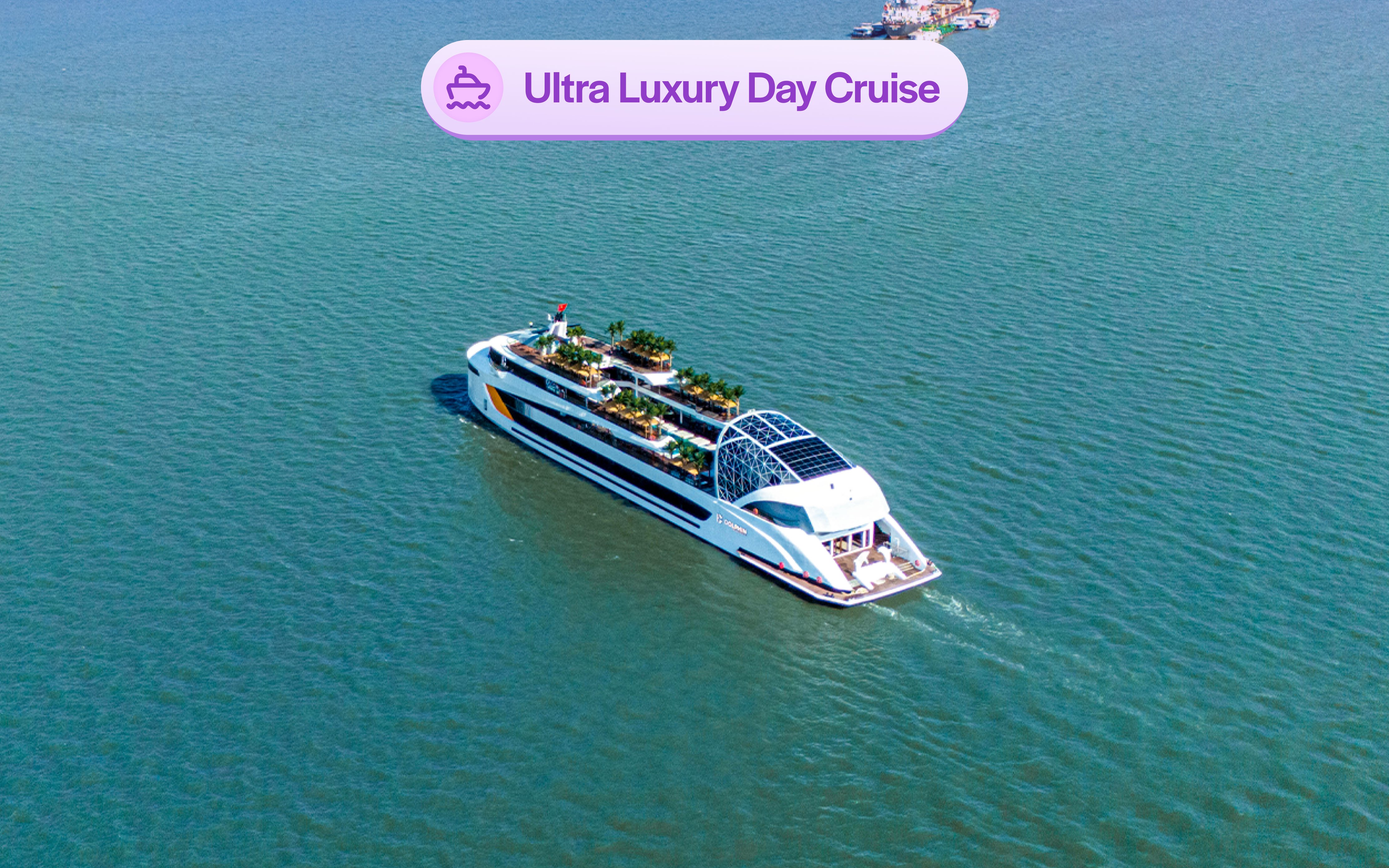 Aerial view of a luxury cruise ship with an infinity pool and sun loungers on deck.