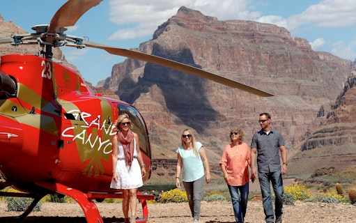 Guests exiting helicopter on Grand Canyon floor tour.