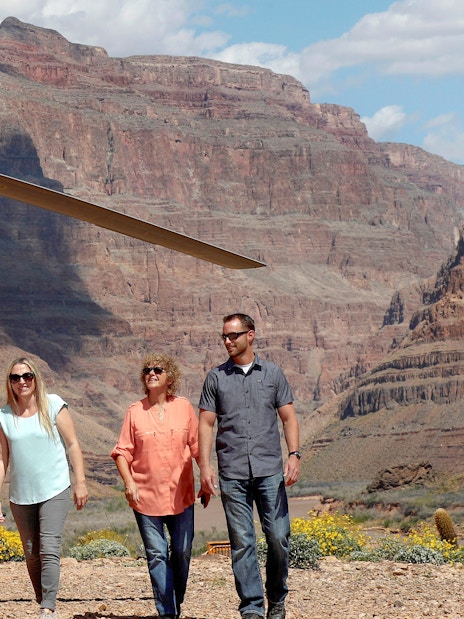 Guests exiting helicopter on Grand Canyon floor tour.