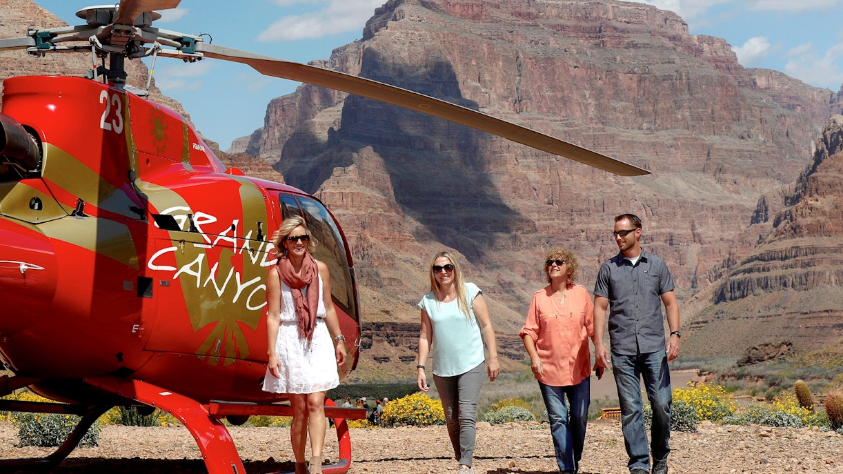 Guests exiting helicopter on Grand Canyon floor tour.
