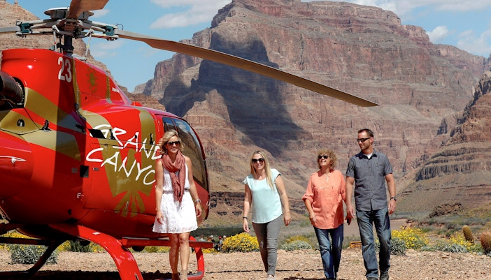 Guests exiting helicopter on Grand Canyon floor tour.