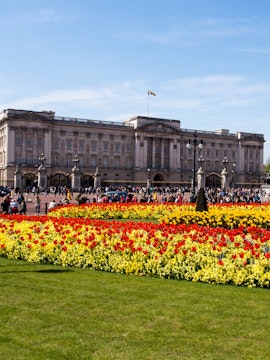 Buckingham Palace with colorful flower gardens in London.