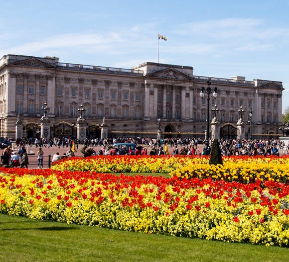 Buckingham Palace with colorful flower gardens in London.