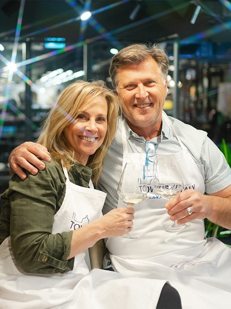 Couple enjoying wine during a pasta-making class in Florence.