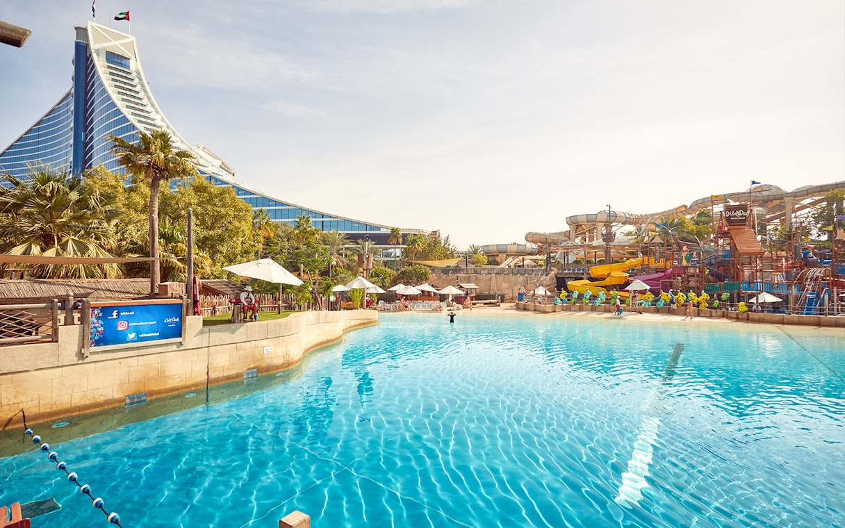 Wild Wadi Waterpark pool with slides and Jumeirah Beach Hotel in Dubai.
