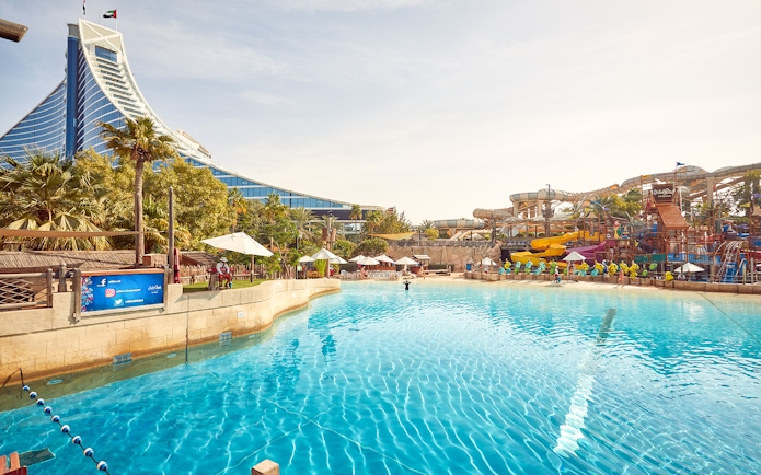 Wild Wadi Waterpark pool with slides and Jumeirah Beach Hotel in Dubai.