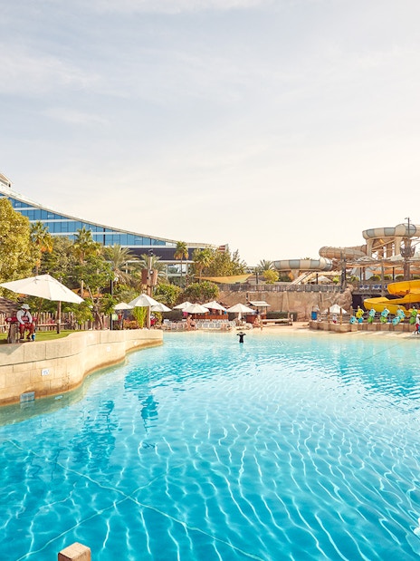 Wild Wadi Waterpark pool with slides and Jumeirah Beach Hotel in Dubai.