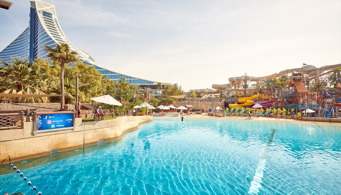 Wild Wadi Waterpark pool with slides and Jumeirah Beach Hotel in Dubai.