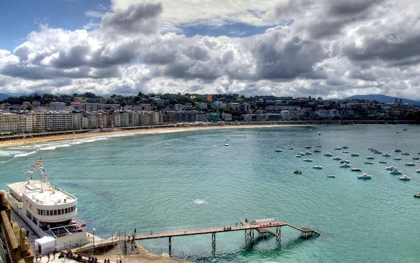Coastal view of San Sebastián with boats in the bay, seen on a full-day Basque Country tour from Bilbao.
