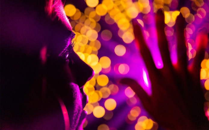 Person experiencing vibrant light display at Infinity Attraction, Gold Coast.