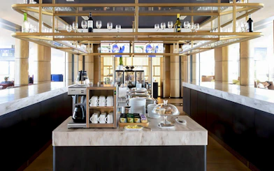 Primeclass Lounge Zurich Airport Terminal E coffee station with cups and snacks.